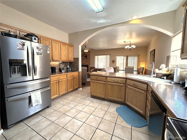 kitchen featuring stainless steel fridge with ice dispenser, arched walkways, a textured ceiling, dishwashing machine, and ceiling fan with notable chandelier