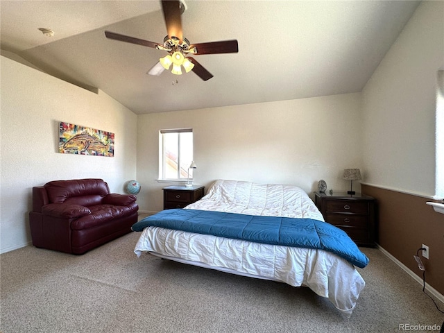bedroom with ceiling fan, vaulted ceiling, and carpet floors