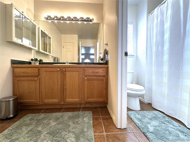 full bath with tile patterned floors, curtained shower, vanity, and toilet