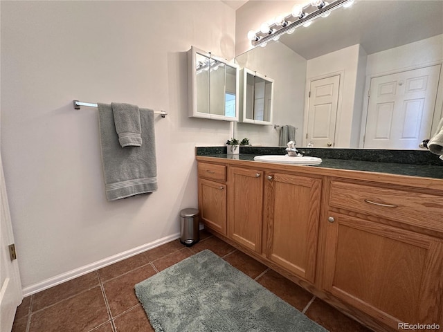 bathroom featuring tile patterned floors, vanity, and baseboards