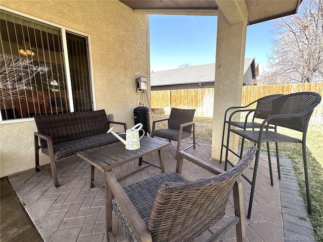view of patio featuring fence