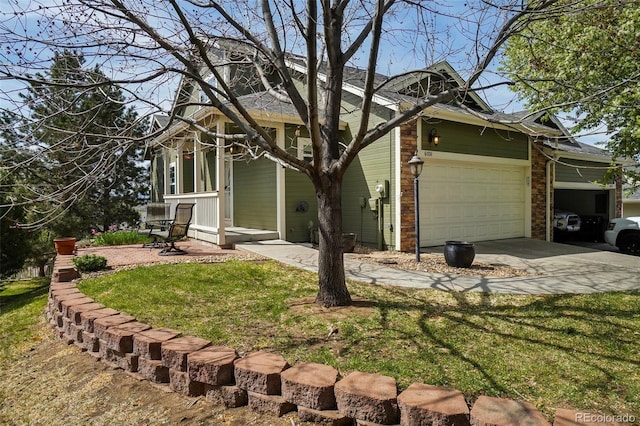 6701 W Yale Ave, Lakewood, CO 80227 - view of front of property featuring driveway, an attached garage, brick siding, and a front yard
