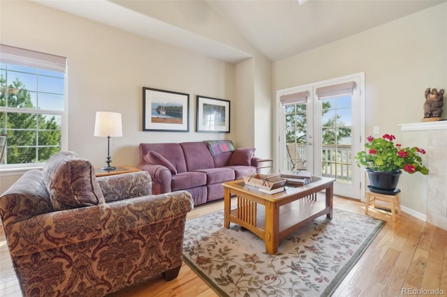 6701 W Yale Ave, Lakewood, CO 80227 - living area featuring light wood-type flooring, lofted ceiling, and baseboards