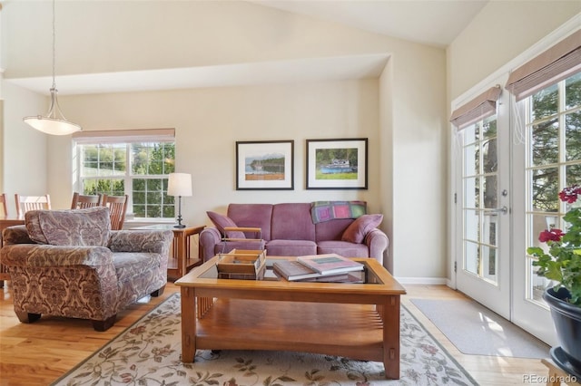 6701 W Yale Ave, Lakewood, CO 80227 - living area featuring light wood-type flooring and vaulted ceiling