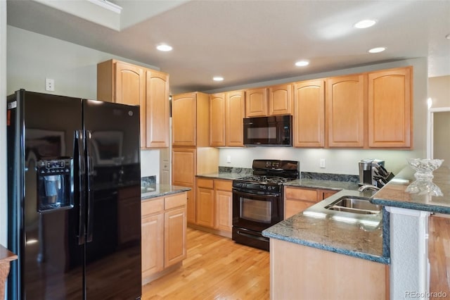 6701 W Yale Ave, Lakewood, CO 80227 - kitchen with black appliances, light brown cabinetry, light wood-style flooring, recessed lighting, and dark stone countertops