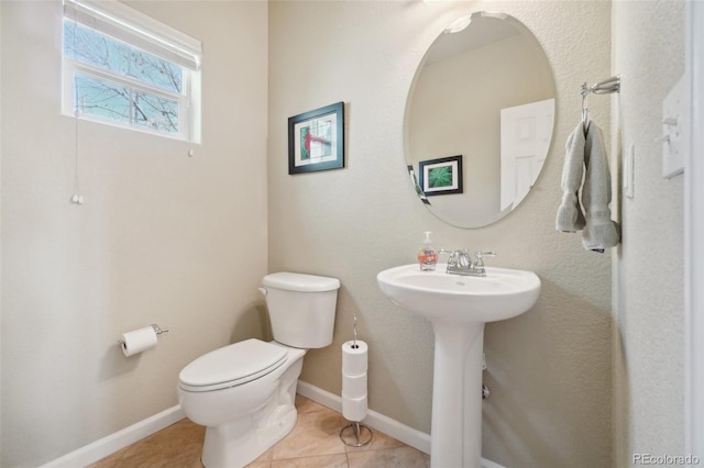 6701 W Yale Ave, Lakewood, CO 80227 - half bath featuring toilet, tile patterned floors, baseboards, and a sink