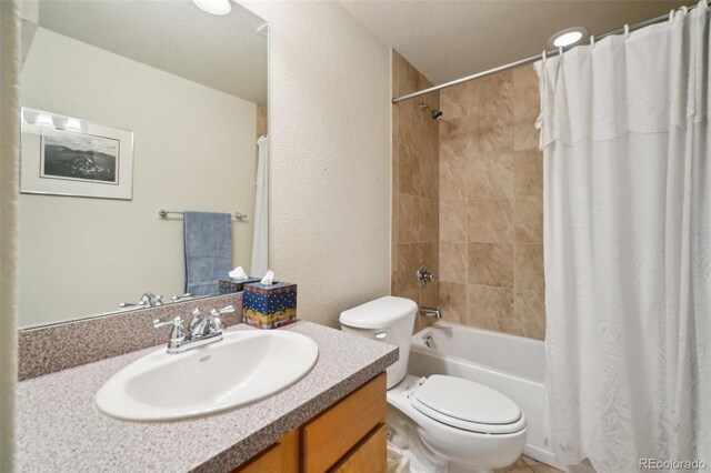 6701 W Yale Ave, Lakewood, CO 80227 - bathroom with toilet, shower / bath combination with curtain, vanity, and a textured wall