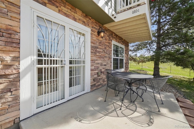 6701 W Yale Ave, Lakewood, CO 80227 - view of patio featuring outdoor dining space and a balcony