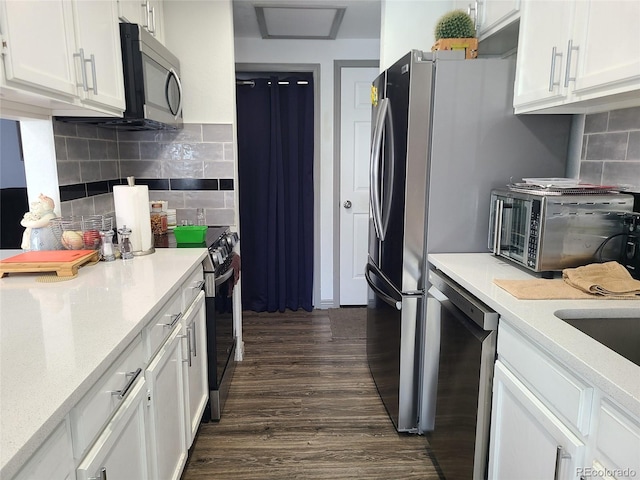 9133 W Cedar Dr Unit A, Lakewood, CO 80226 - kitchen featuring stainless steel appliances, white cabinetry, dark wood-type flooring, and backsplash
