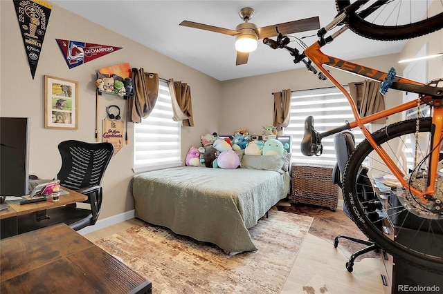 bedroom with ceiling fan and light wood-type flooring