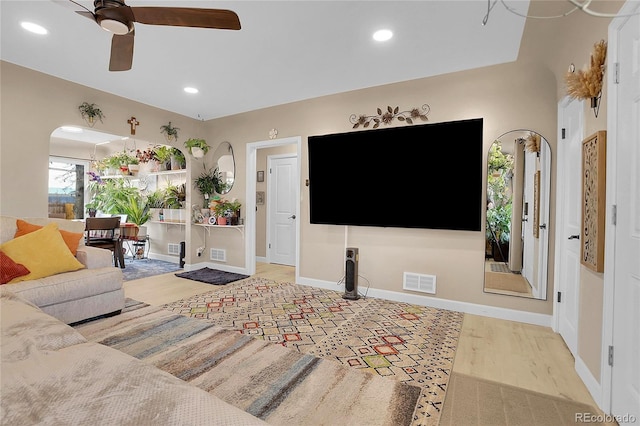 living room with light hardwood / wood-style flooring and ceiling fan