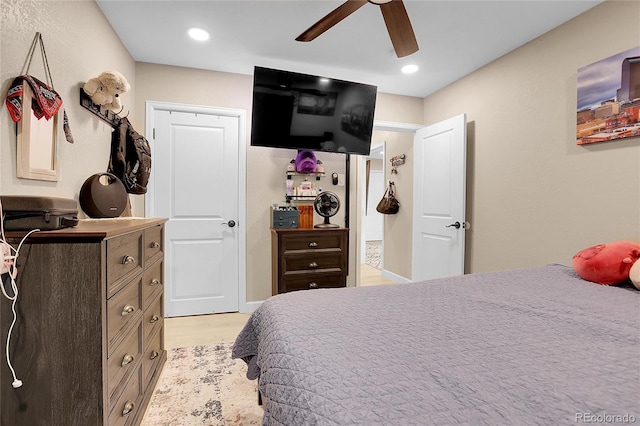 bedroom with light hardwood / wood-style floors and ceiling fan