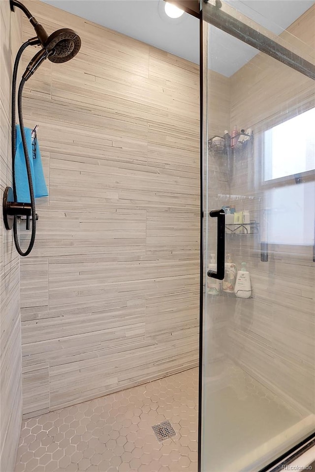 bathroom with a shower with door