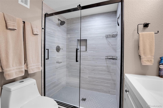 bathroom featuring toilet and an enclosed shower