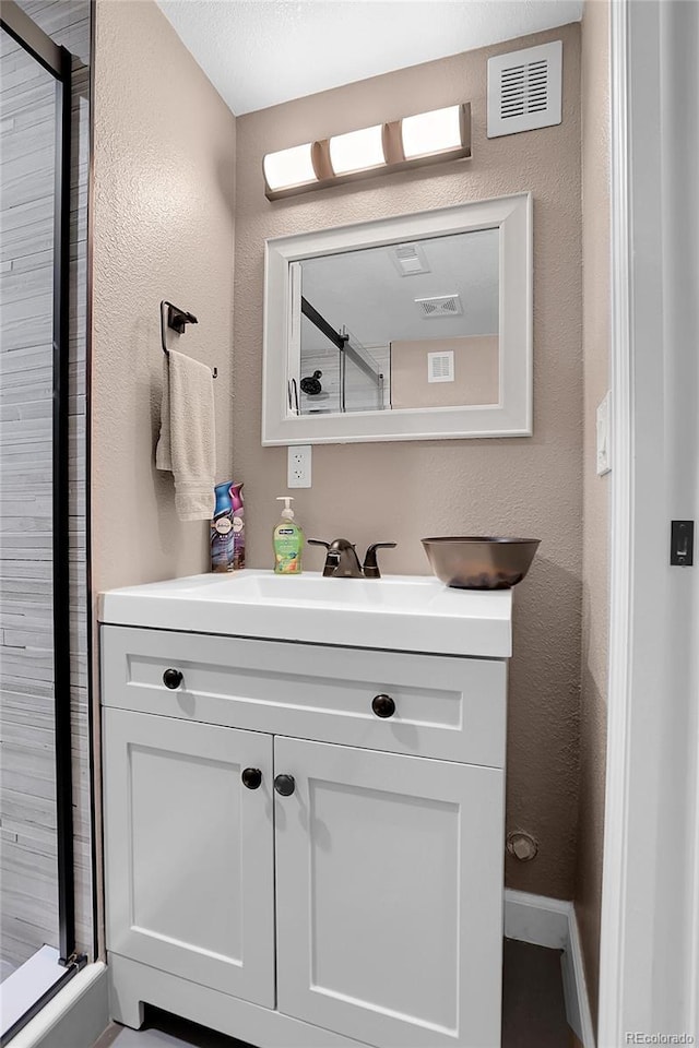 bathroom with vanity and an enclosed shower