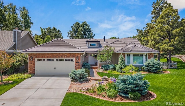 10 Oakmont Ln, Littleton, CO 80127 - view of front of house featuring brick siding, an attached garage, a front yard, driveway, and a tile roof