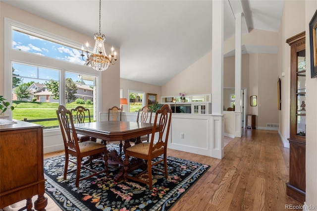 10 Oakmont Ln, Littleton, CO 80127 - dining space featuring high vaulted ceiling, light wood finished floors, a chandelier, and beamed ceiling