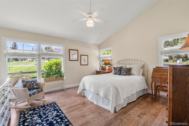 10 Oakmont Ln, Littleton, CO 80127 - bedroom featuring light wood-type flooring, multiple windows, vaulted ceiling, and a ceiling fan