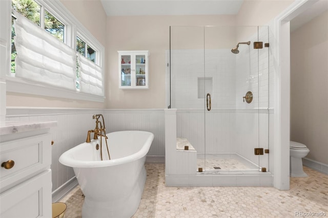 10 Oakmont Ln, Littleton, CO 80127 - bathroom with a stall shower, a freestanding tub, and wainscoting