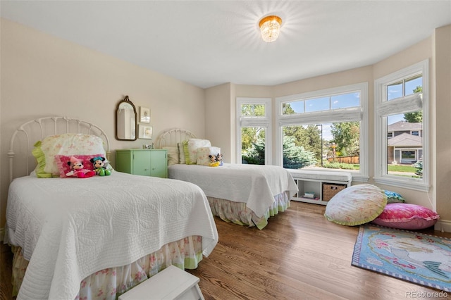 10 Oakmont Ln, Littleton, CO 80127 - bedroom with multiple windows and wood finished floors