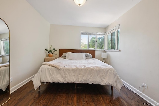1497 S Garfield St, Denver, CO 80210 - bedroom featuring multiple windows, wood finished floors, and arched walkways
