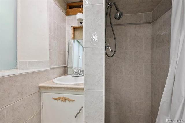 1497 S Garfield St, Denver, CO 80210 - bathroom featuring vanity, tiled shower, and tile walls