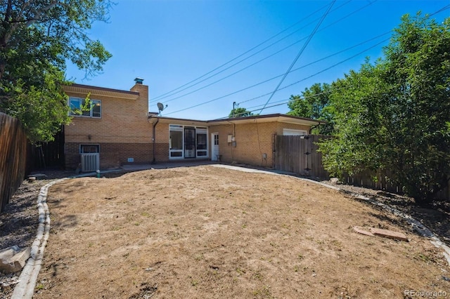 1497 S Garfield St, Denver, CO 80210 - rear view of property with brick siding, a chimney, and a patio area