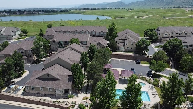 drone / aerial view with a water and mountain view