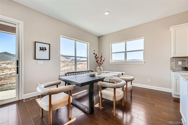 dining space with dark hardwood / wood-style floors