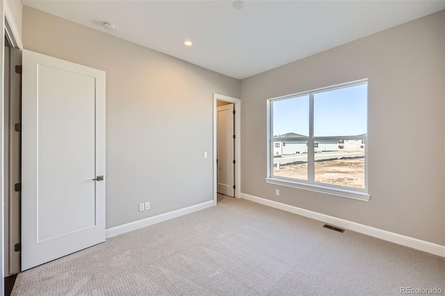 unfurnished bedroom with light carpet