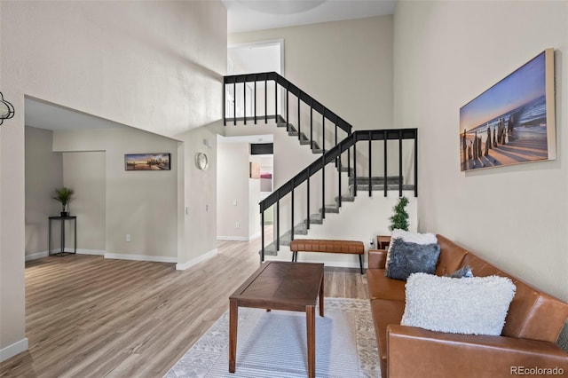 13025 E Bethany Pl, Aurora, CO 80014 - living area with wood finished floors, stairway, and a towering ceiling