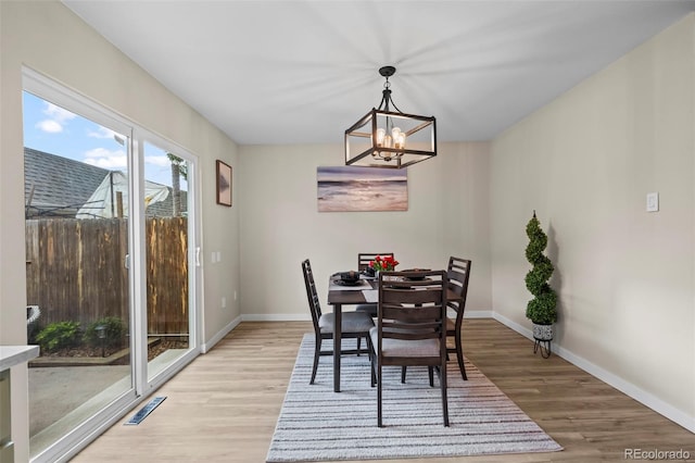 13025 E Bethany Pl, Aurora, CO 80014 - dining room with light wood-style flooring and a chandelier