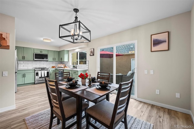 13025 E Bethany Pl, Aurora, CO 80014 - dining room with a chandelier and light wood-style floors