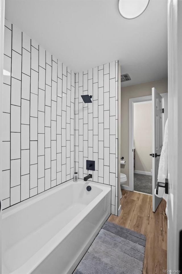 13025 E Bethany Pl, Aurora, CO 80014 - full bath featuring washtub / shower combination and wood finished floors