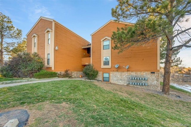 view of side of property with a yard