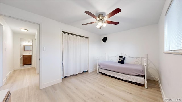 bedroom featuring ensuite bath, ceiling fan, and light hardwood / wood-style floors