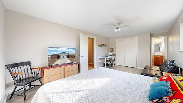 bedroom featuring ceiling fan, light hardwood / wood-style floors, connected bathroom, and a closet