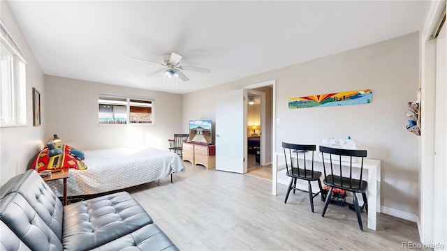 bedroom with a closet, ceiling fan, and light hardwood / wood-style flooring