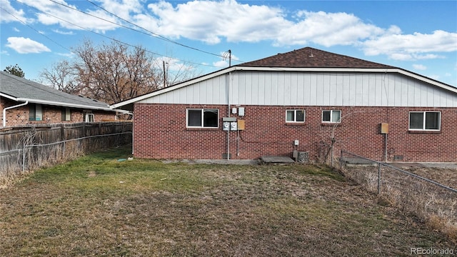 view of side of home with a lawn