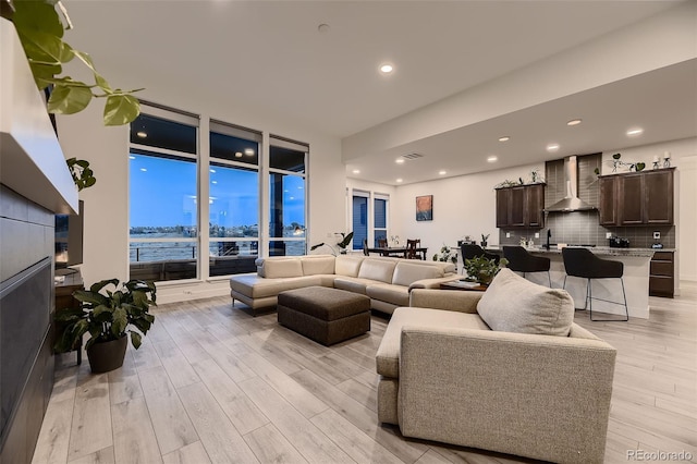 8868 Geyser Peak Way, Parker, CO 80138 - living room with light wood-type flooring, floor to ceiling windows, and recessed lighting