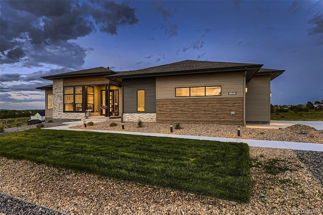 8868 Geyser Peak Way, Parker, CO 80138 - back of property featuring a lawn and stone siding