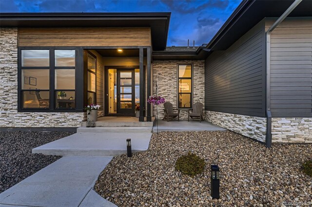 8868 Geyser Peak Way, Parker, CO 80138 - view of exterior entry featuring stone siding and covered porch