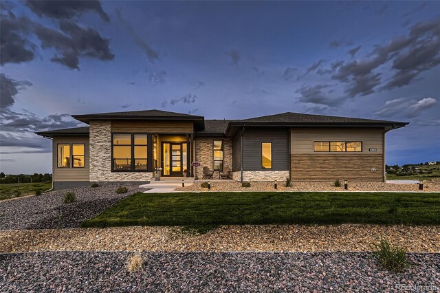 8868 Geyser Peak Way, Parker, CO 80138 - back of house with stone siding and a lawn