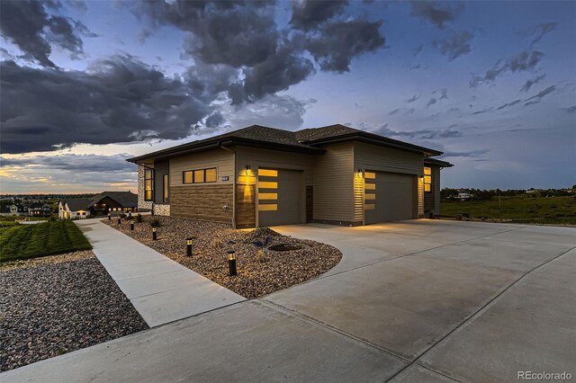 8868 Geyser Peak Way, Parker, CO 80138 - view of front of home with a garage, stone siding, and concrete driveway