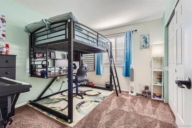 bedroom with carpet flooring, a textured ceiling, and a closet