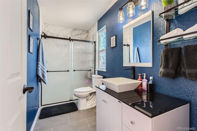 bathroom with walk in shower, vanity, toilet, and a textured ceiling