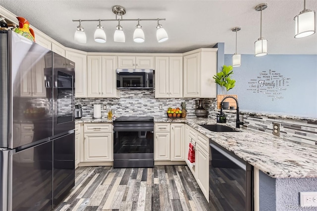 kitchen featuring tasteful backsplash, sink, decorative light fixtures, and stainless steel appliances