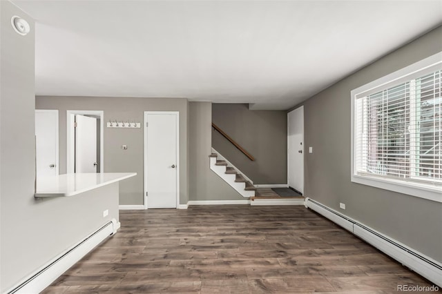 foyer entrance featuring dark hardwood / wood-style floors and a baseboard heating unit