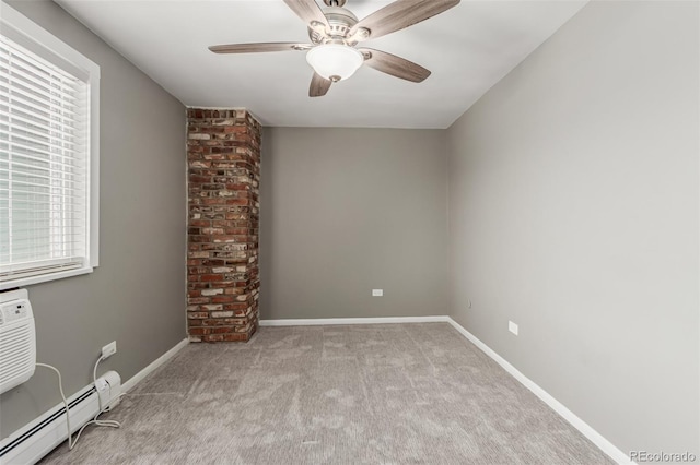 carpeted spare room with baseboard heating and ceiling fan