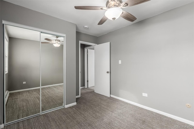 unfurnished bedroom with dark colored carpet, ceiling fan, a baseboard radiator, and a closet